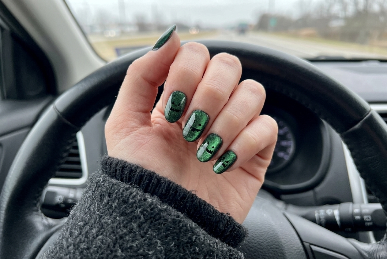 Glamnetic emerald green cat-eye velvet pumpkin almond press-on nails shifting under warm light